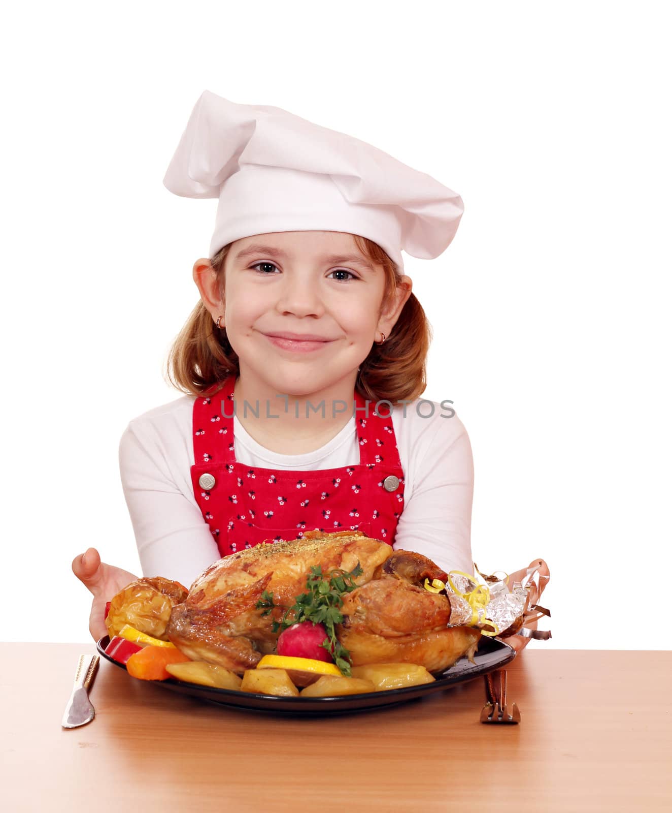 beautiful little girl cook with roasted chicken on table by goce