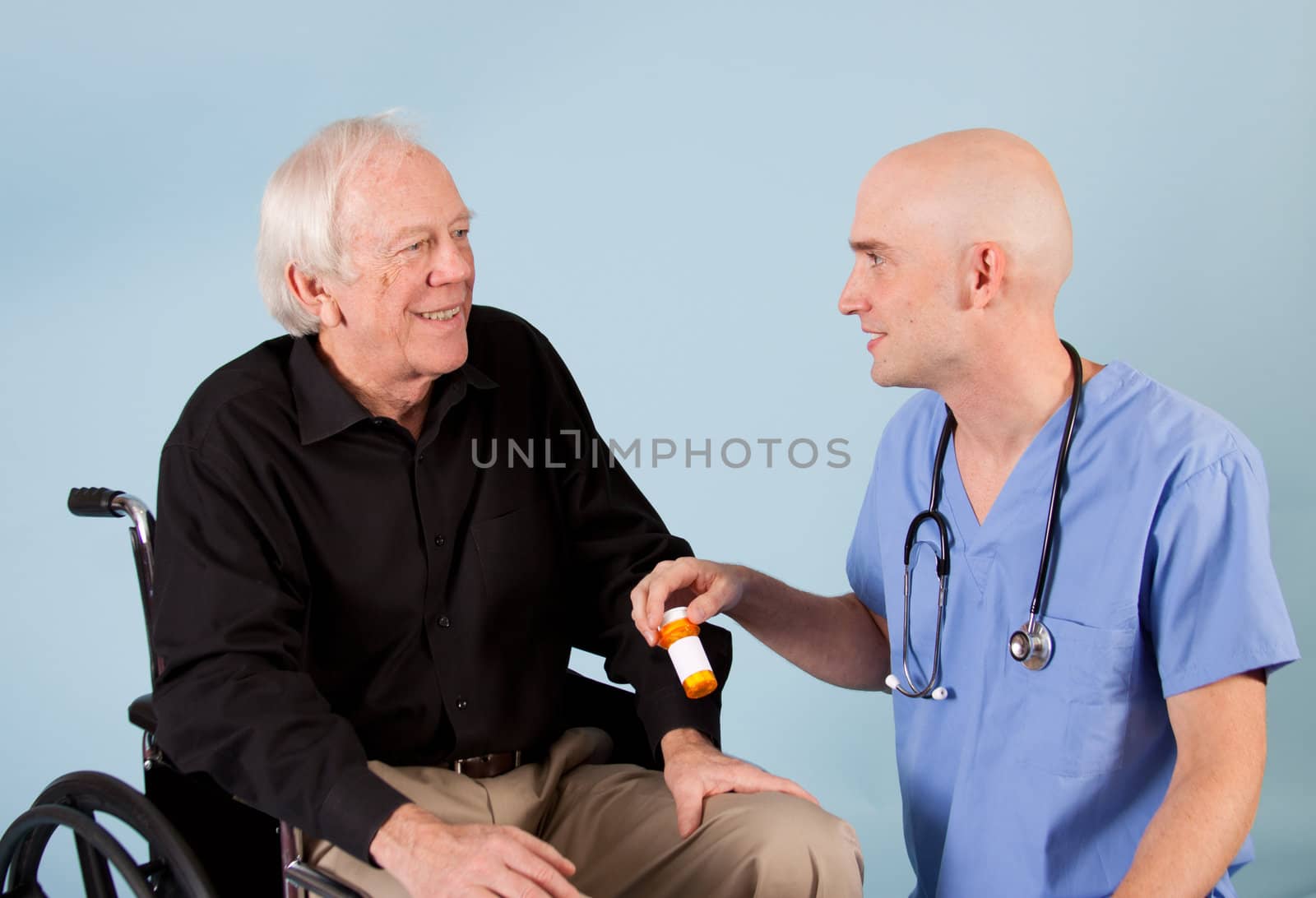 Doctor talks about perscription with elderly patient.