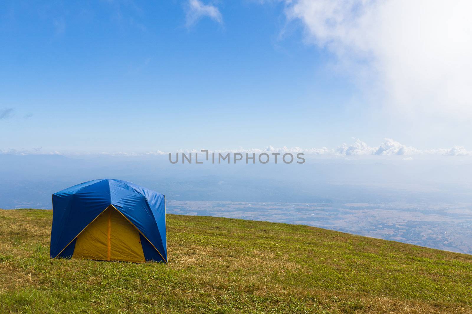 Tent on a grass under  blue sky by stoonn