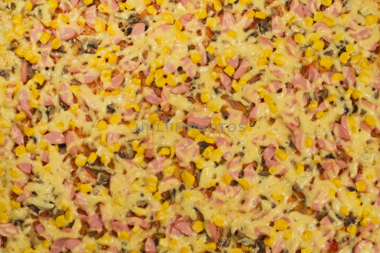 Large pizza closeup with cheese, sausage, corn and mushrooms, view from the top.