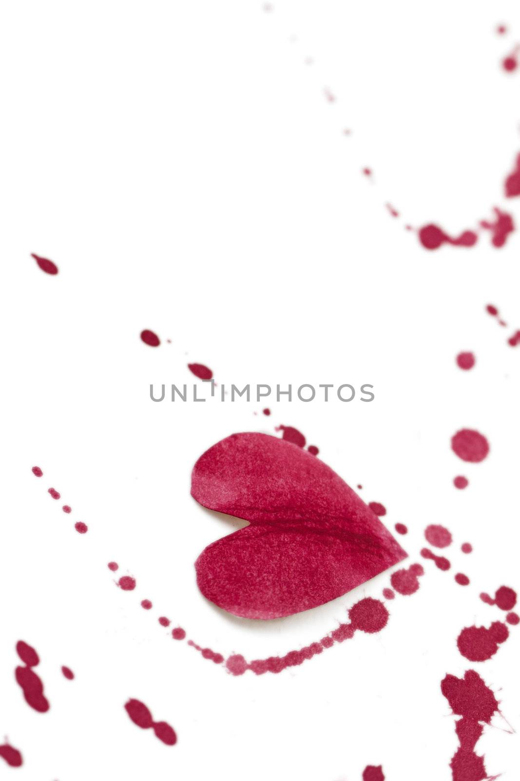 White background with a paper heart and red splashes