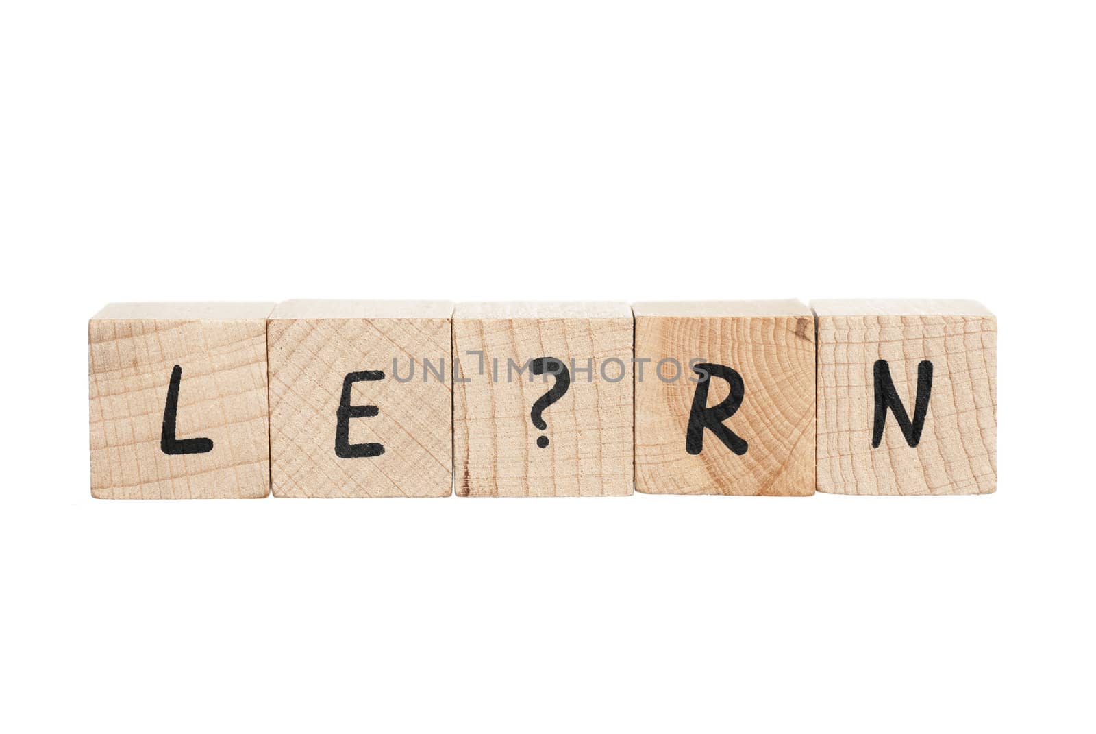 Learn spelled out with wooden blocks. White background.