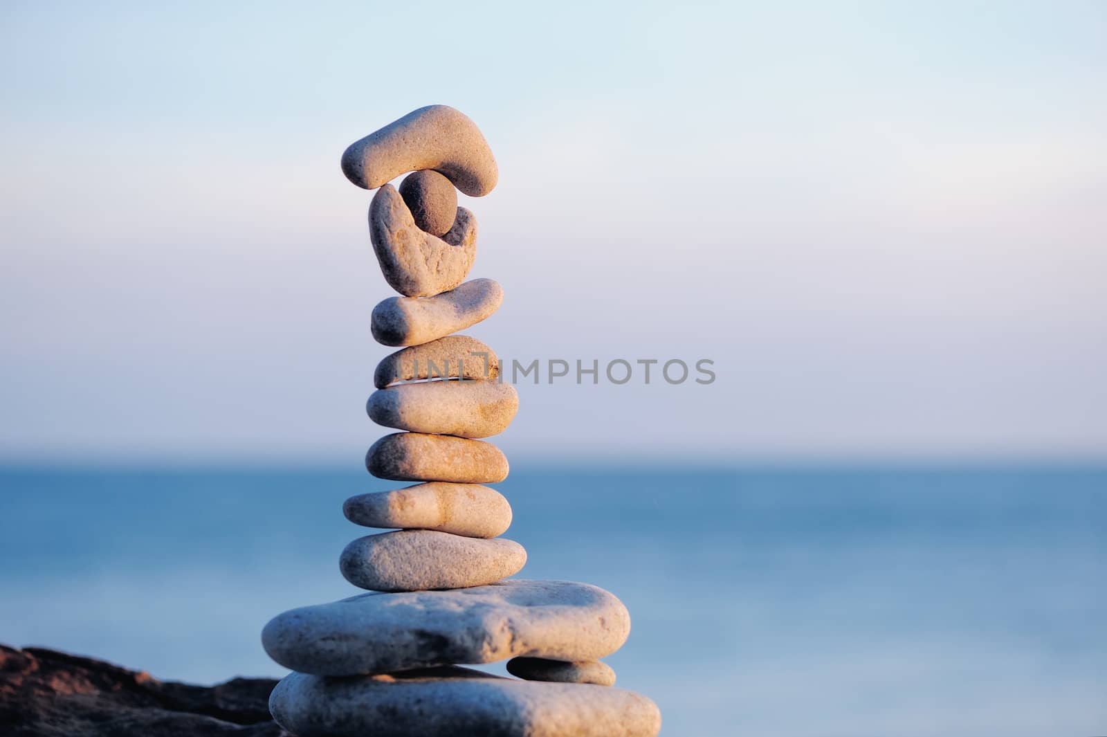 Pile of pebbles each other on a sea boulder