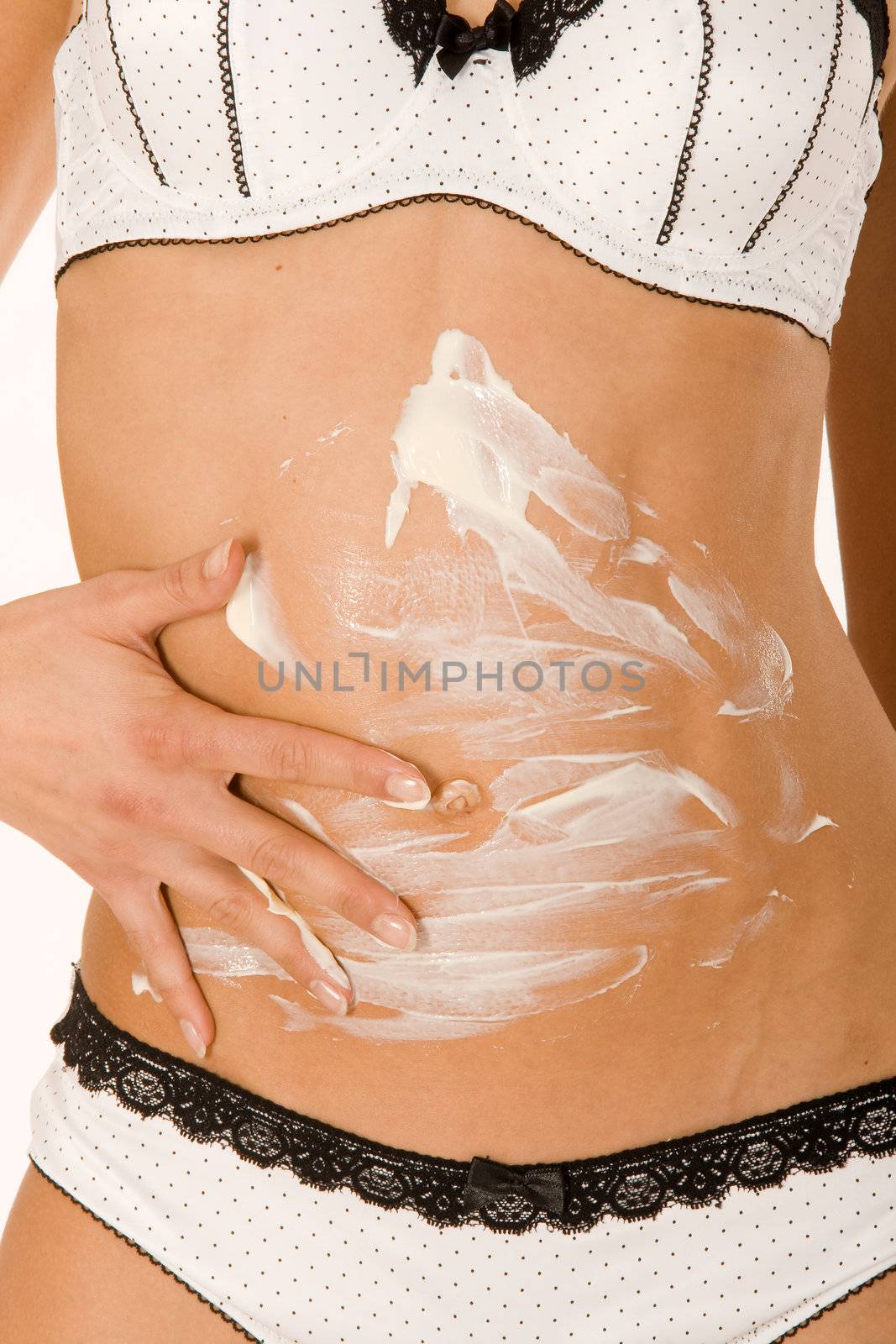 Woman in white lingerie creaming himself in the abdomen