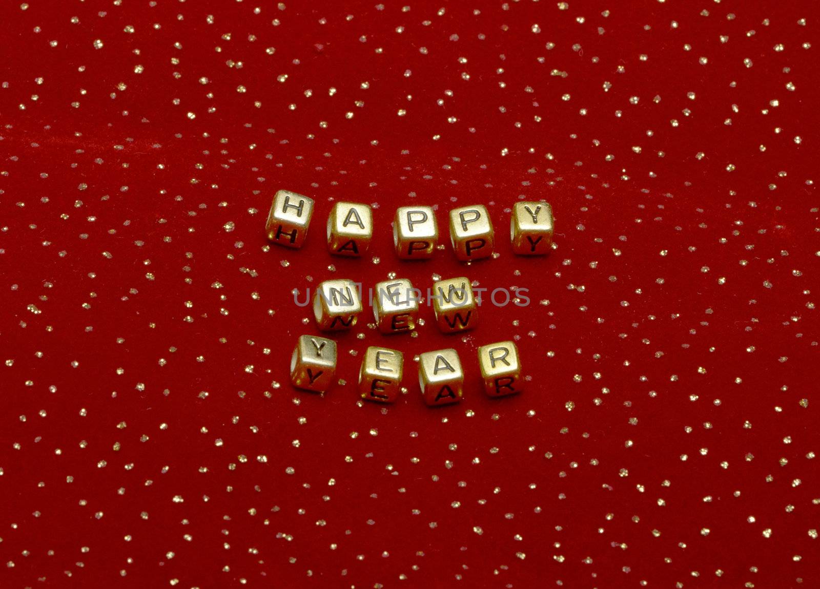 phrase "happy new year" of beads on a red velvet with sequins by Discovod