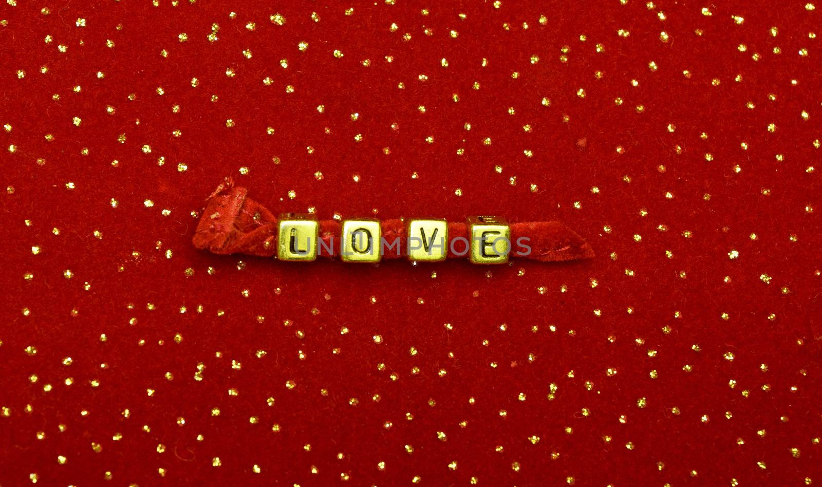 photo of word of love beads on red velvet with sequins