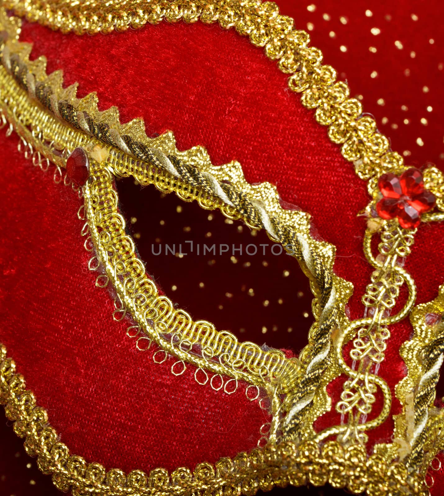 photo of fragment theatrical mask on red background