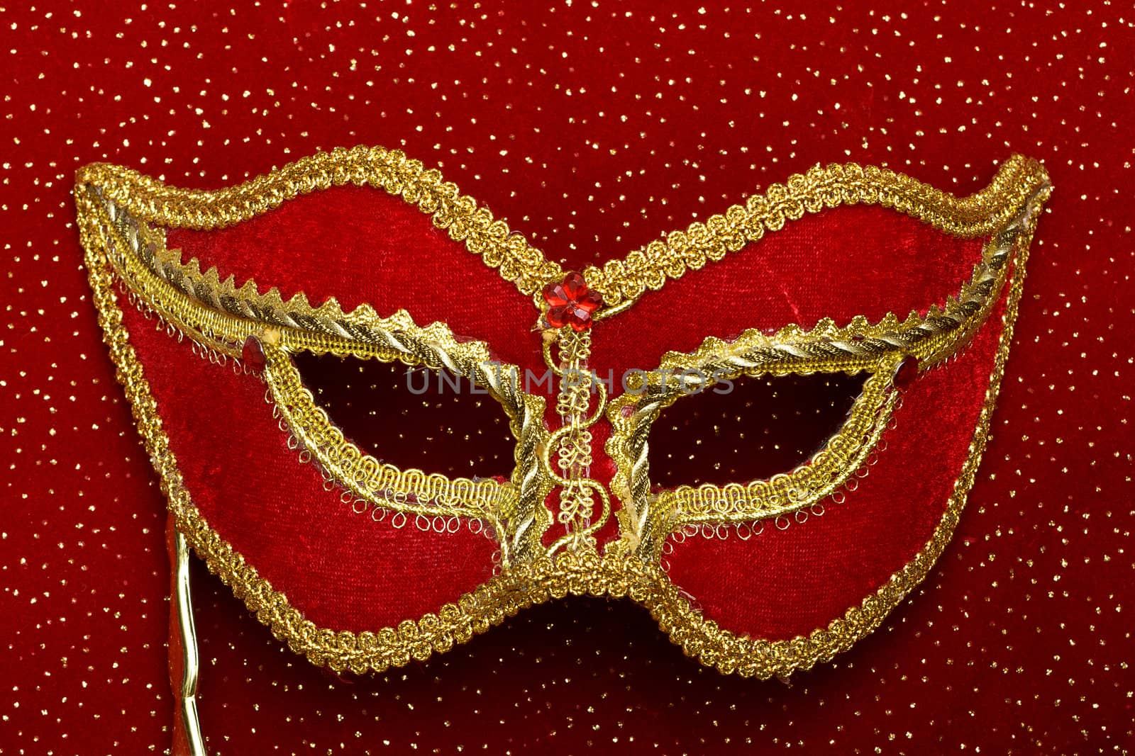 photo of theatrical mask on red background