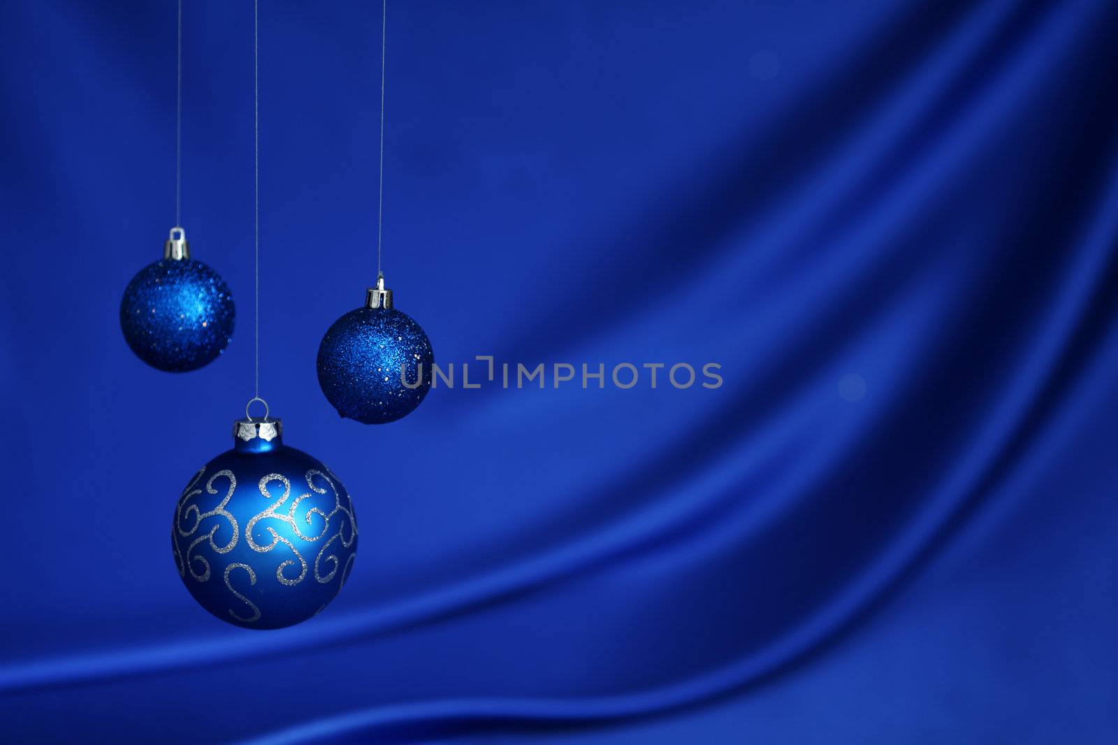 christmas balls on blue satin background