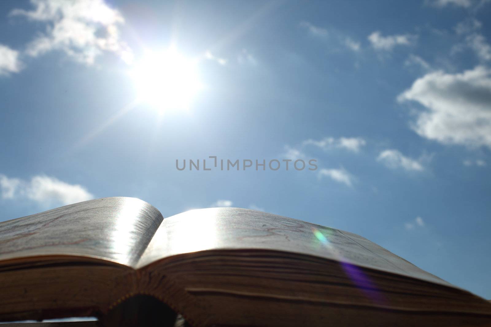  book of wisdom on sun sky background