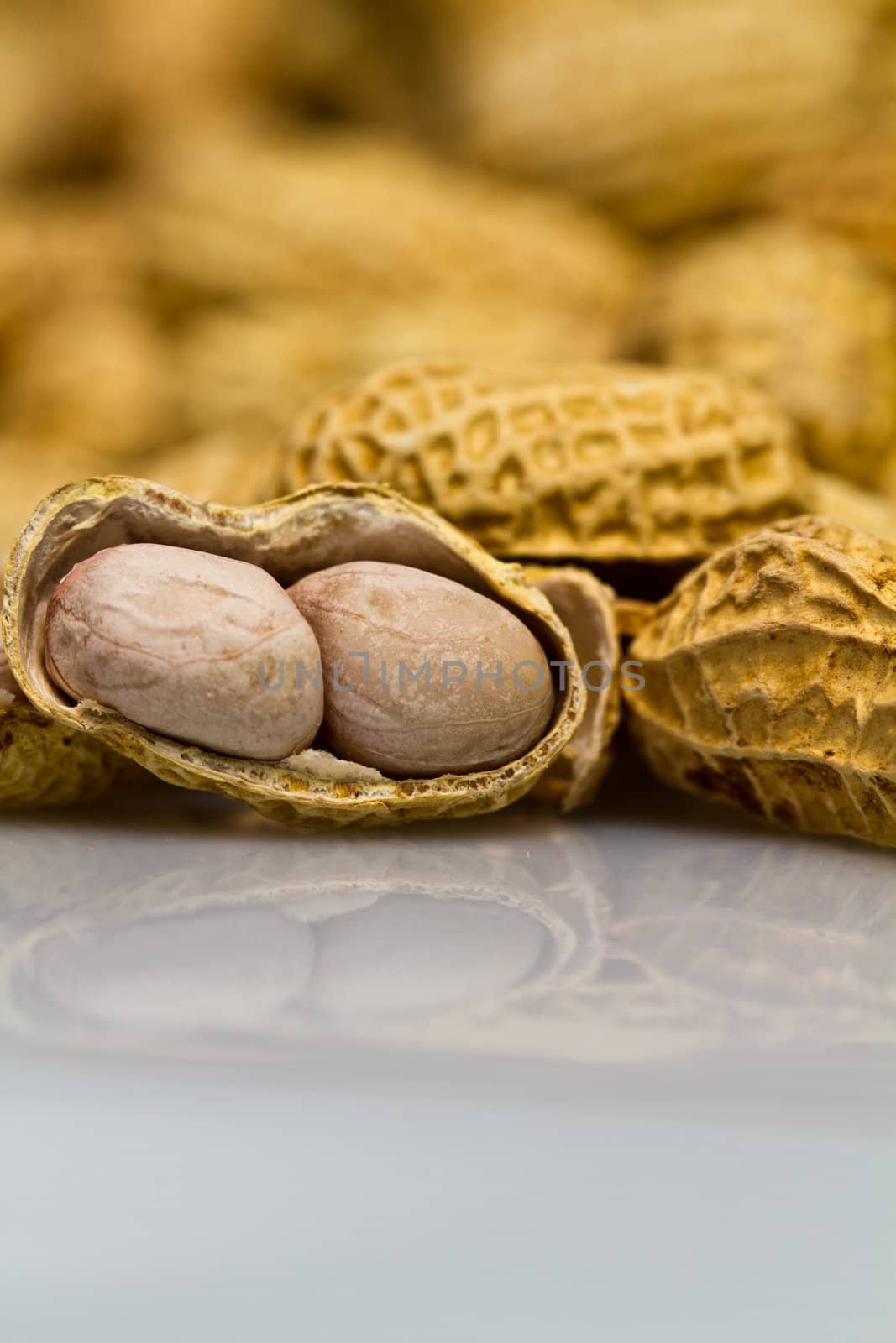 Close up view of an opened groundnut in portrait orientation as background