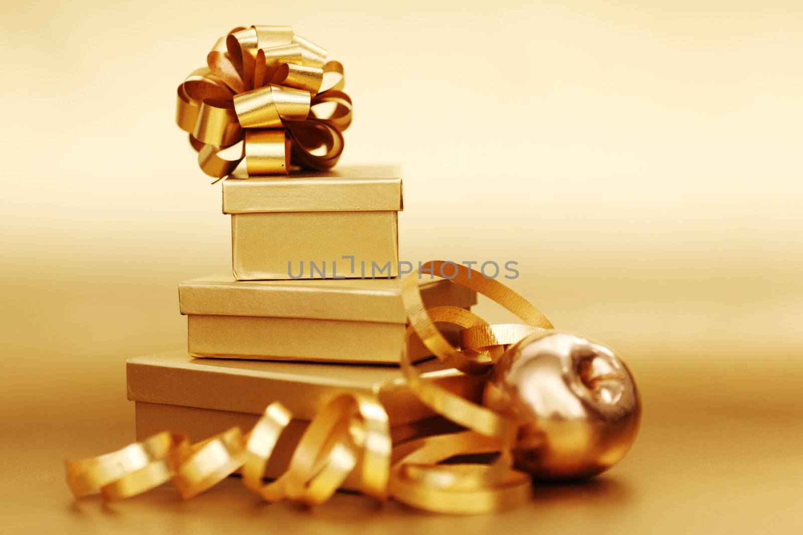 golden christmas gifts on gold background 