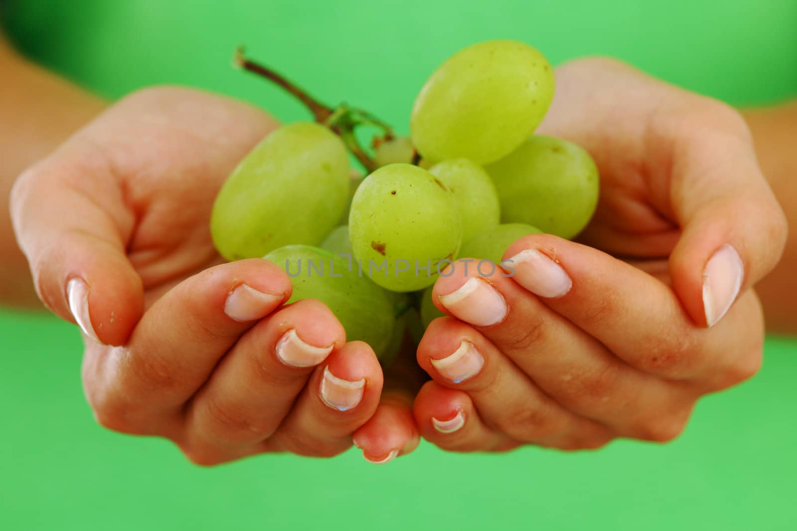 grape in woman hands close up