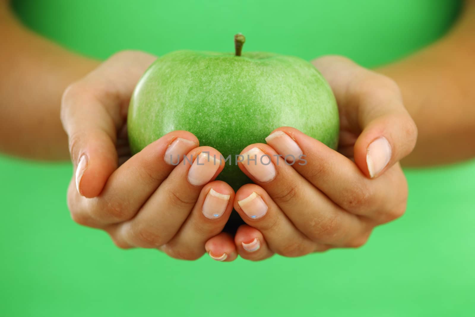 apple in woman hands close up