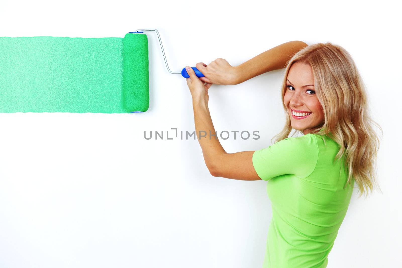 woman paints the wall brush