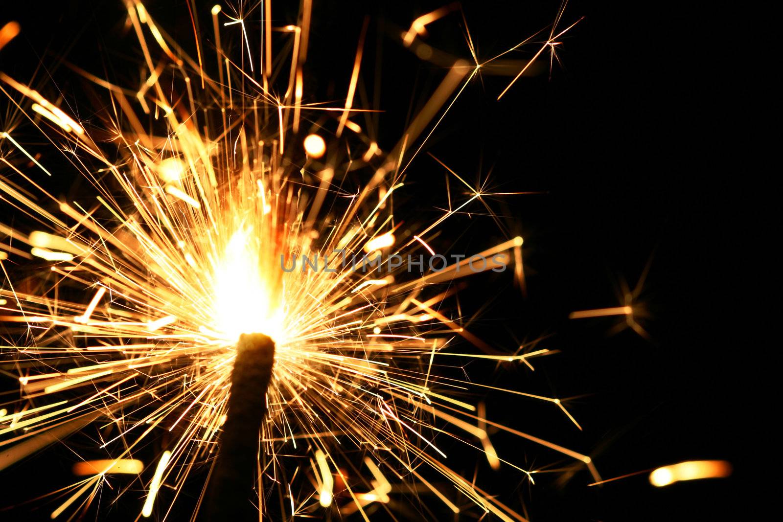 yellow sparkler holiday background on black