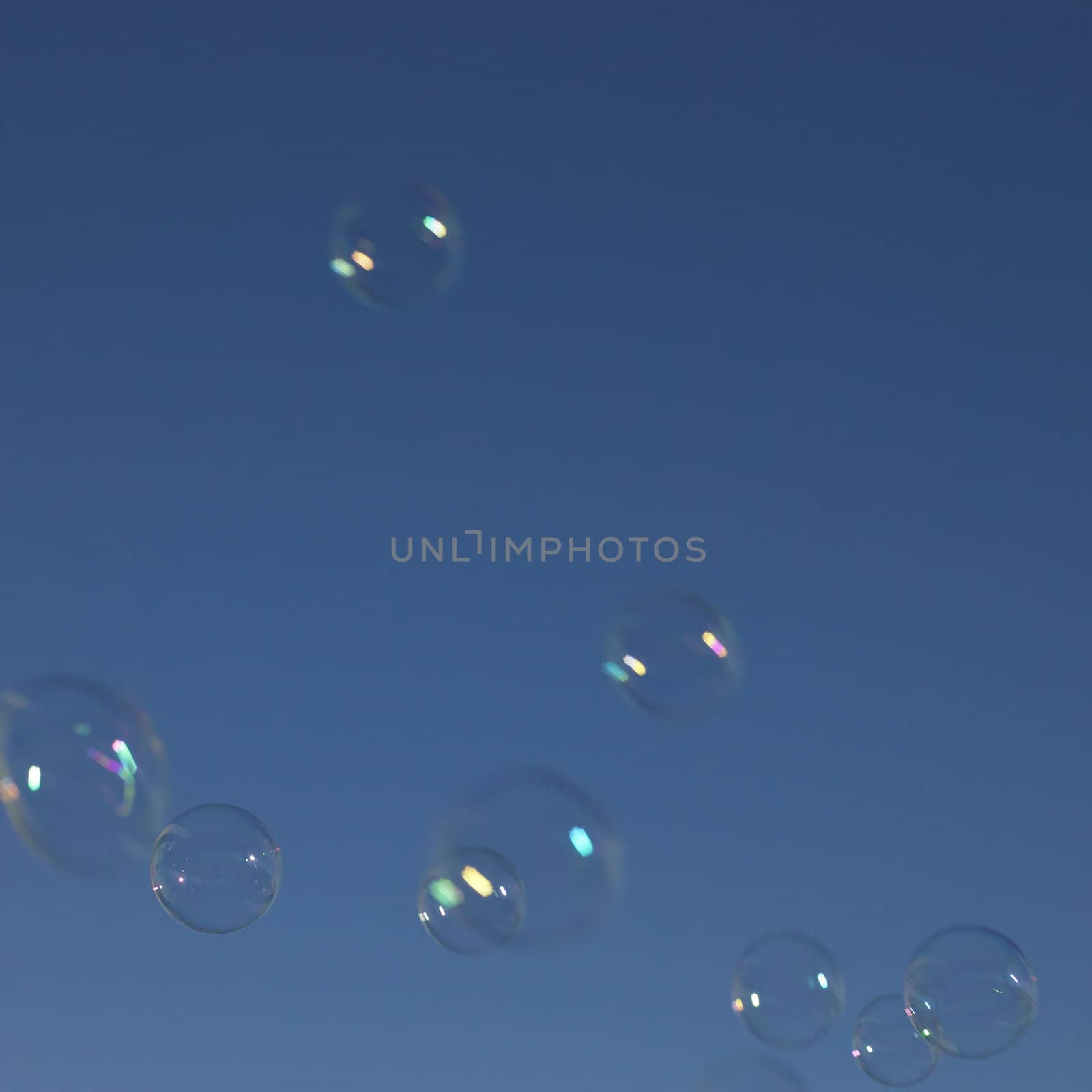 Soap bubbles in the blue sky