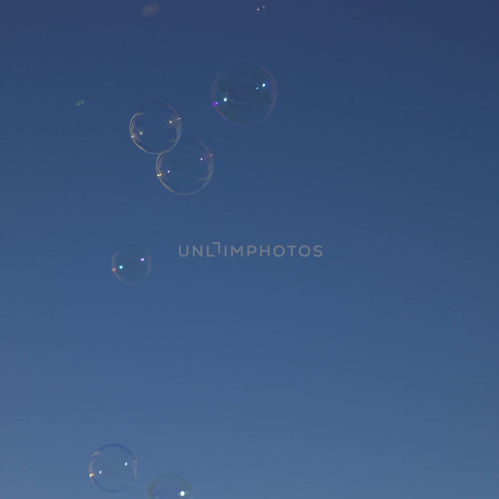 Soap bubbles in the blue sky