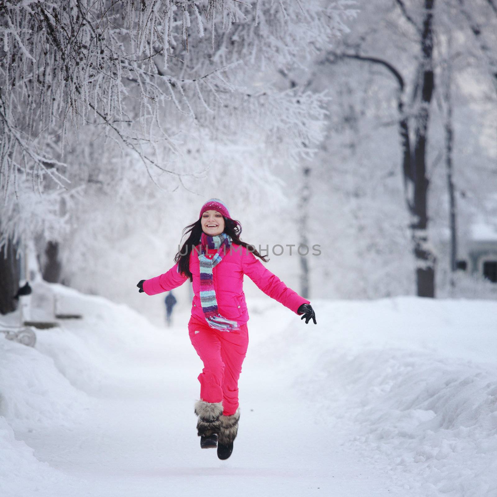 woman run in winter park very happy
