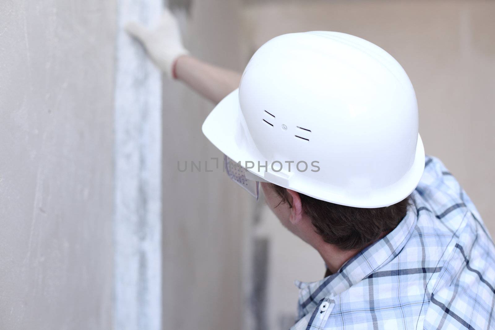 worker aligns wall for directing