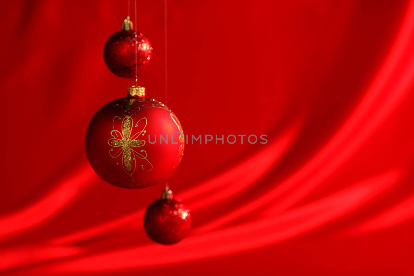  christmas balls on red satin background