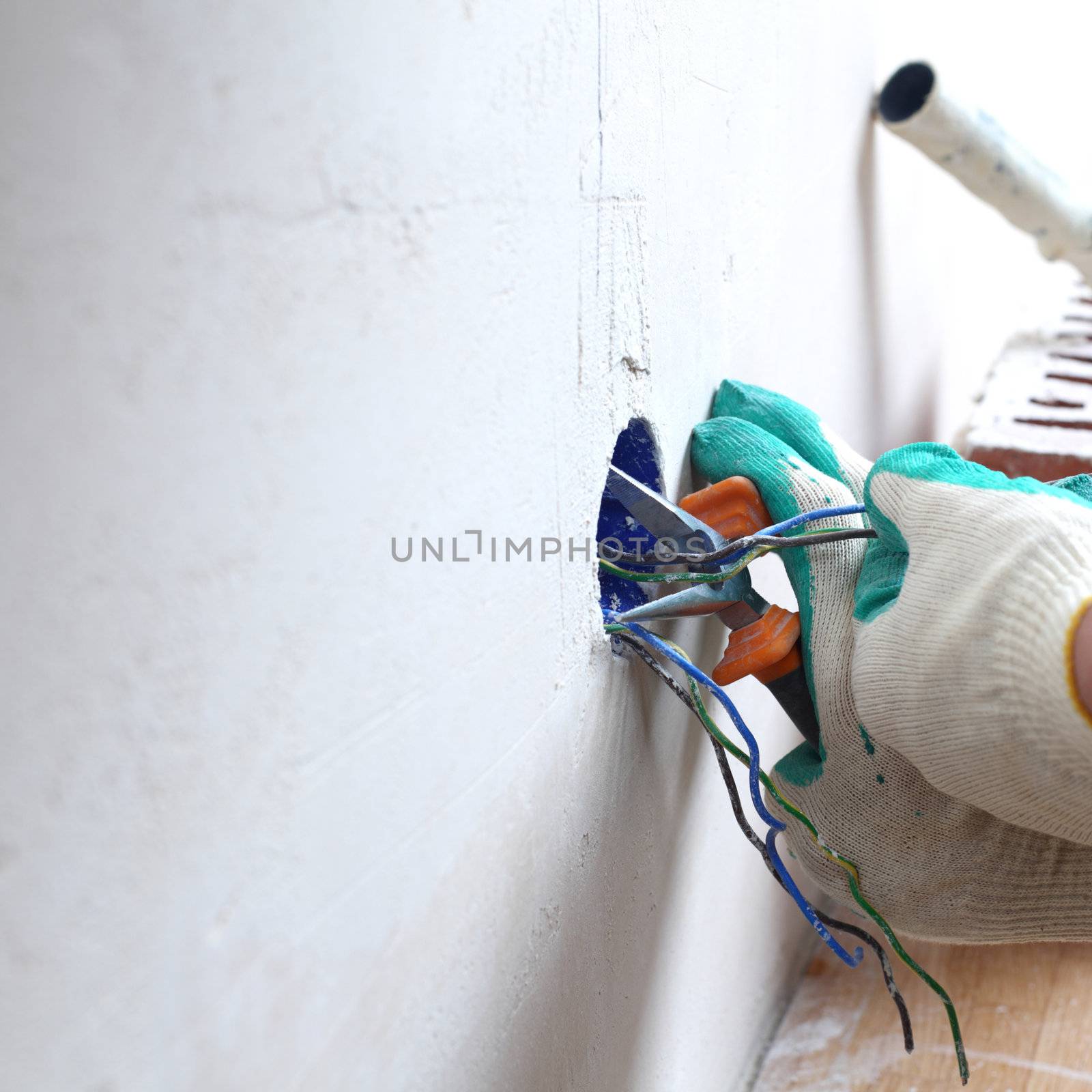 worker puts the wires in the wall