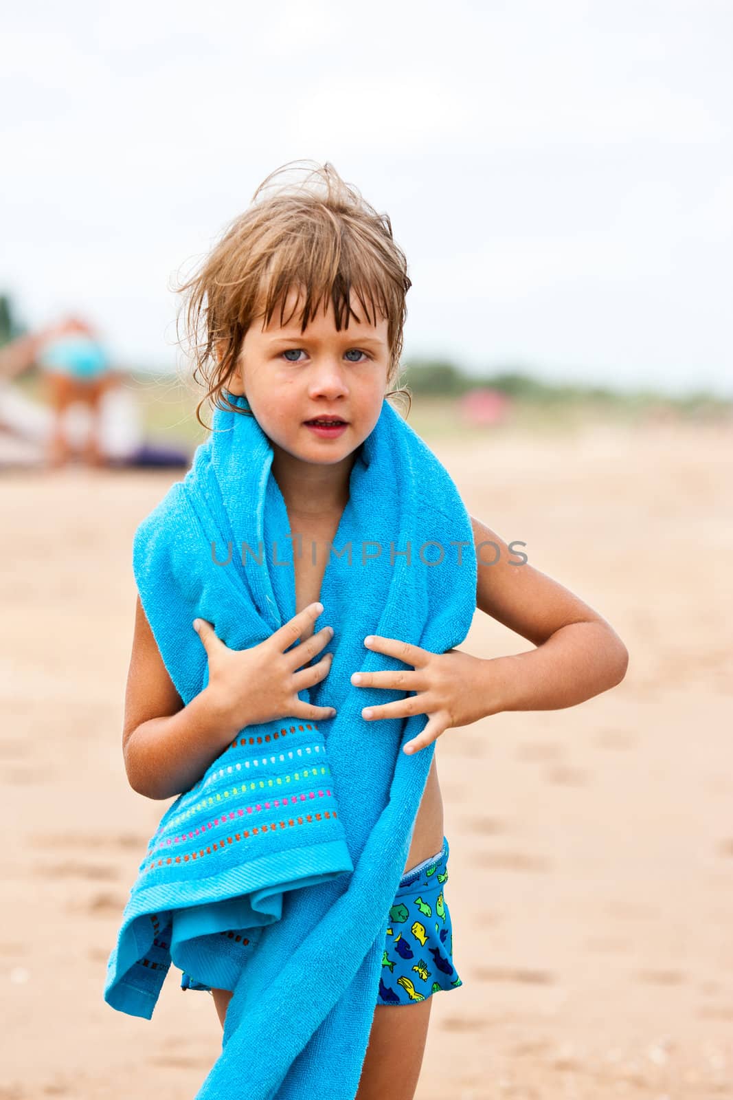 people series: litle girl with blue towel on the sea beach
