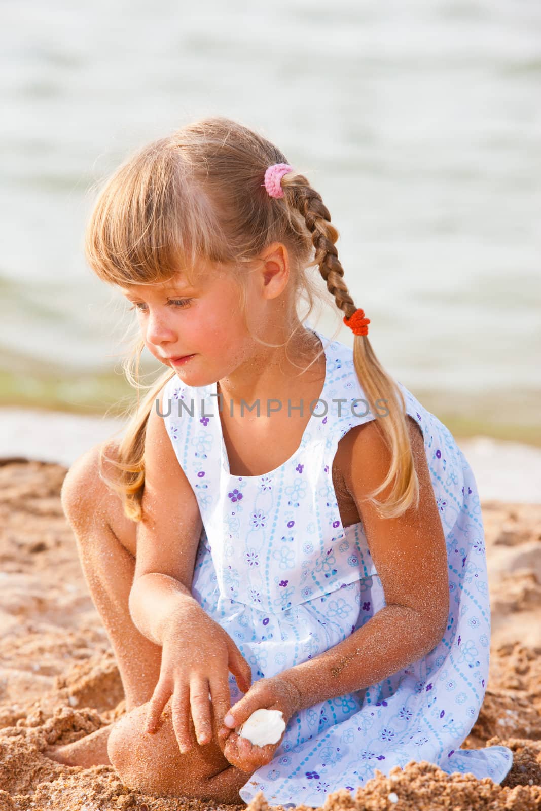 people series: little girl on sea beach are play the sandy game