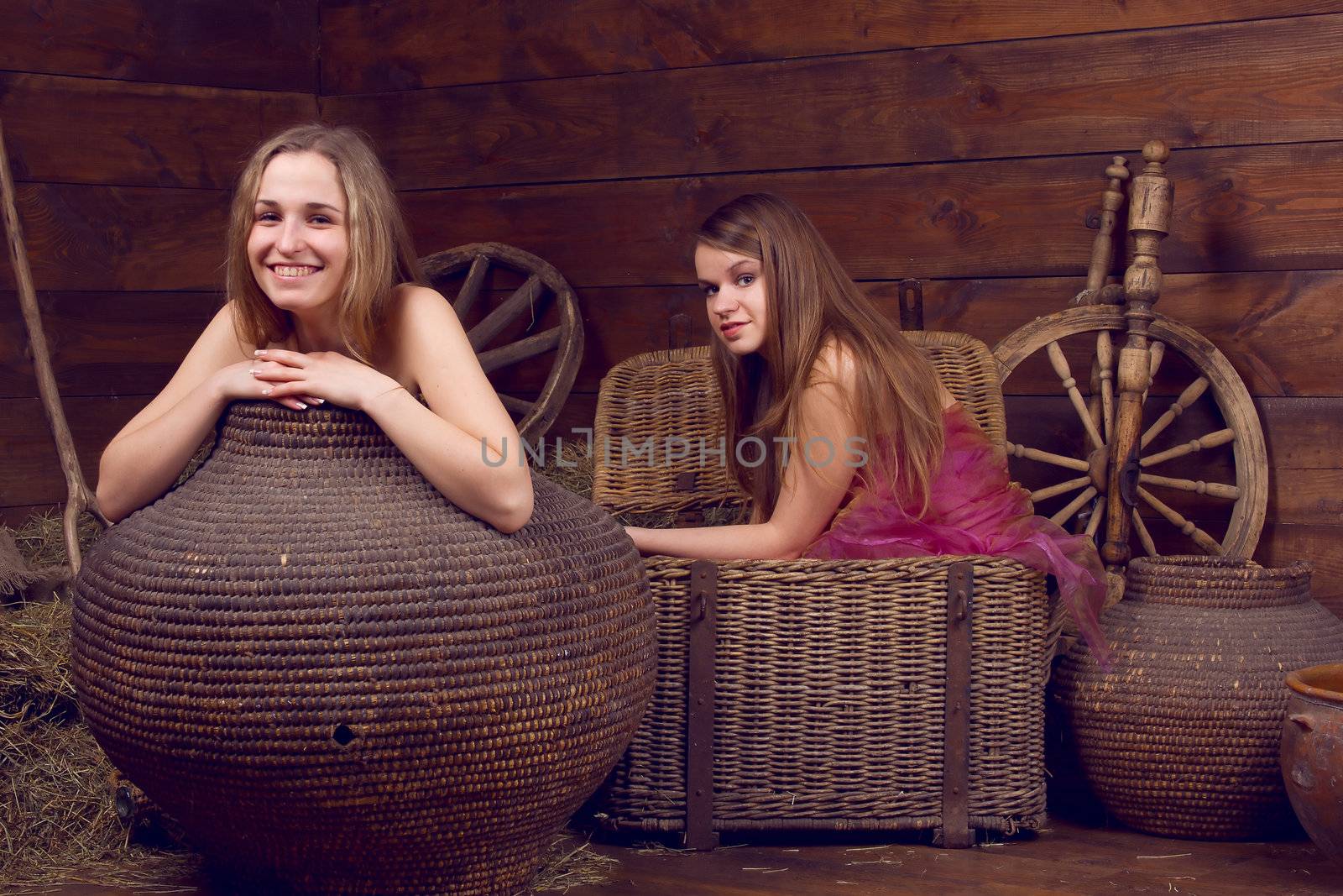 2 girls hidden in baskets near the hay