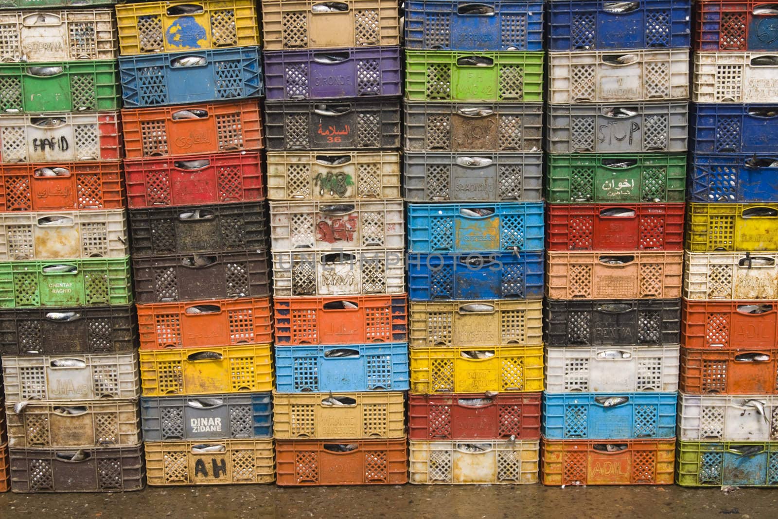 Stack of colorful packing cases containing recently landed fish in the fishing village of Essaouira, Morocco.