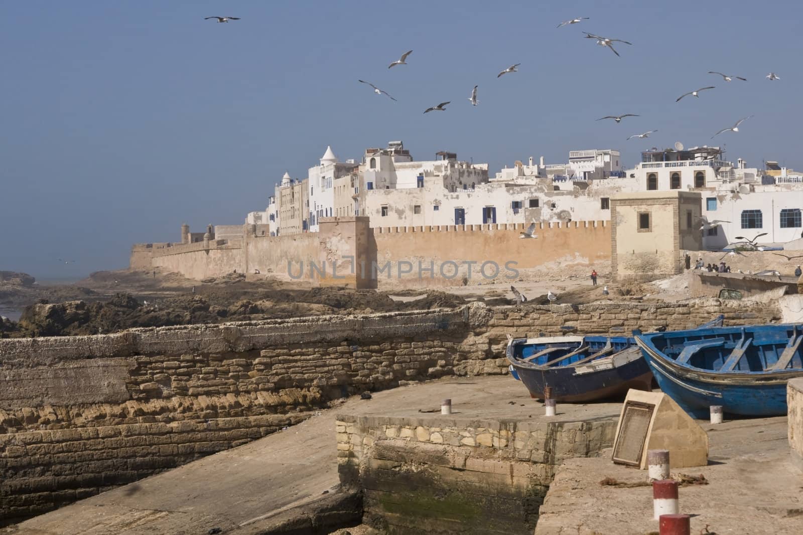 Small fishing boats on the dockside in the historic seaside village of Essaouira in Morocco.