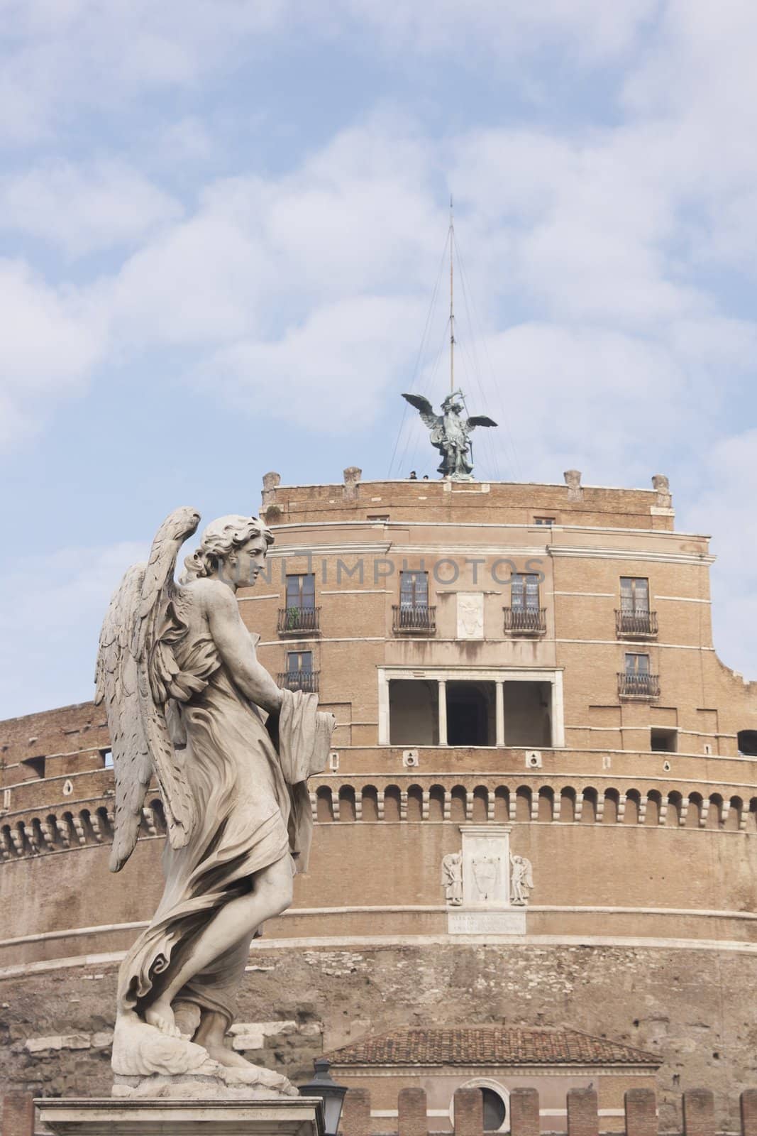 Statue of an Angel on the bridge (Pont Sant' Angelo) over the River Tiber leading to the ancient Castel Sant' Angelo in Rome, Italy.