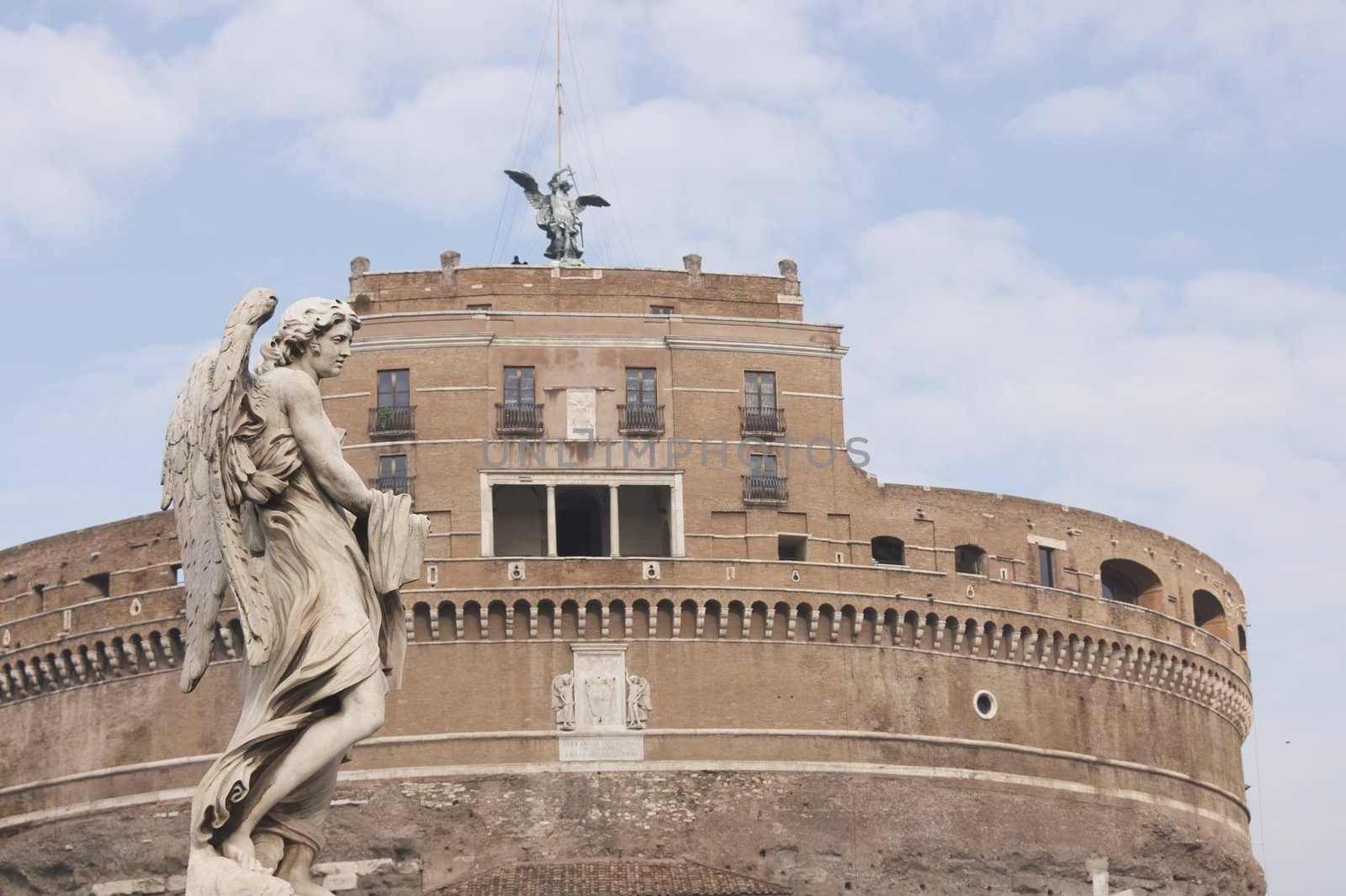 Statue of an Angel on the bridge (Pont Sant' Angelo) over the River Tiber leading to the ancient Castel Sant' Angelo in Rome, Italy.