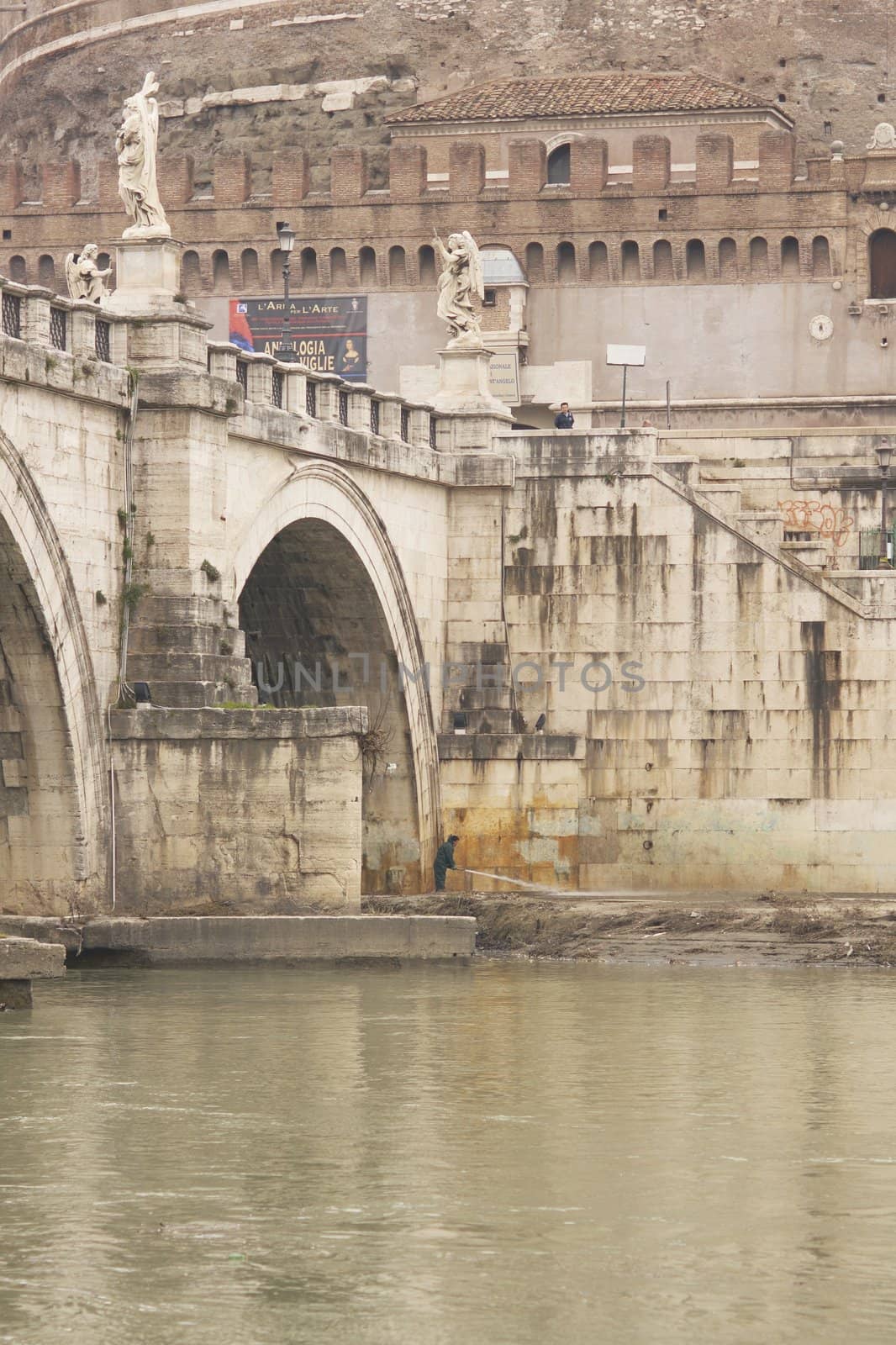 Statues line the bridge (Pont Sant' Angelo) over the River Tiber leading to the ancient Castel Sant' Angelo in Rome, Italy.