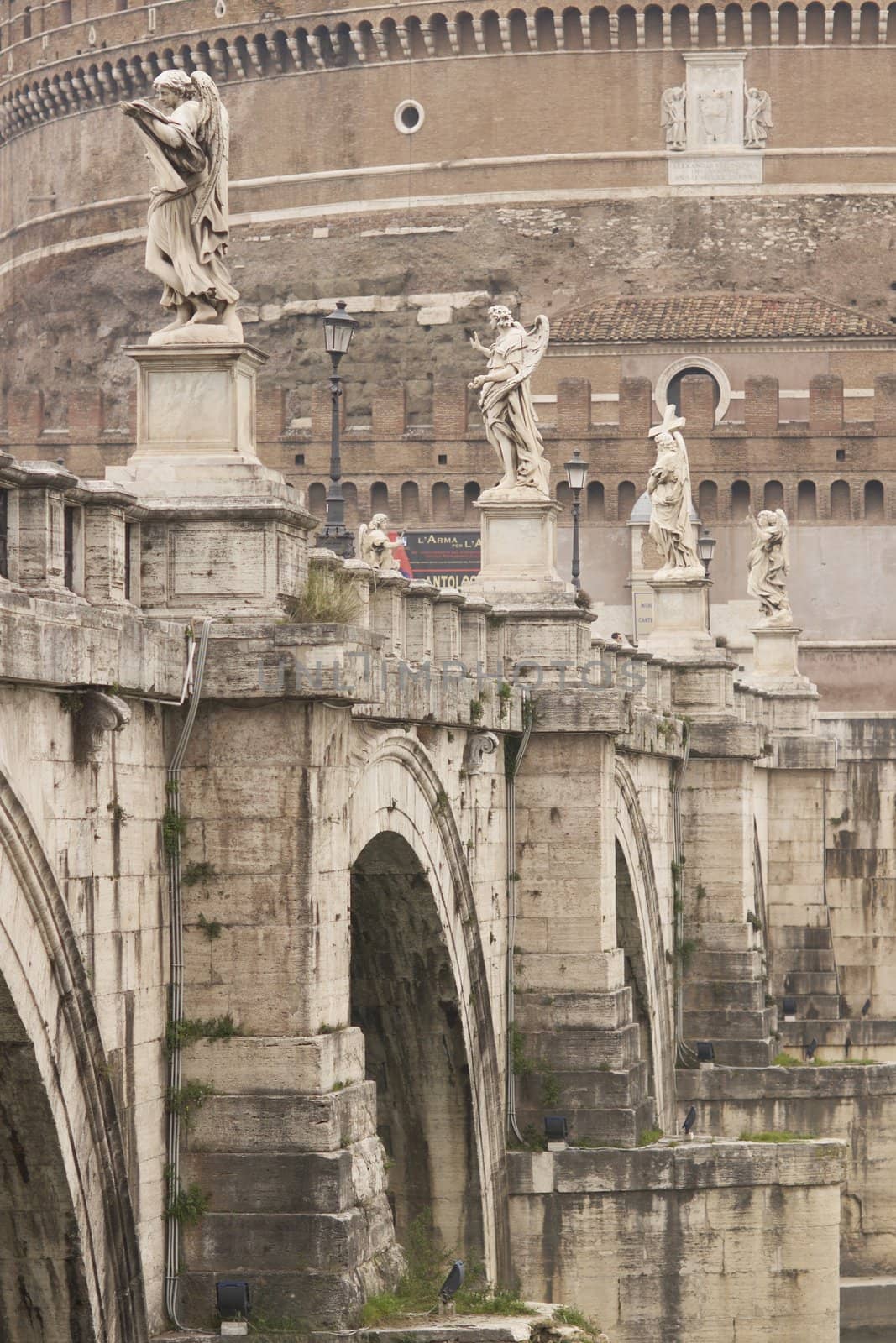 Statues line the bridge (Pont Sant' Angelo) over the River Tiber leading to the ancient Castel Sant' Angelo in Rome, Italy.
