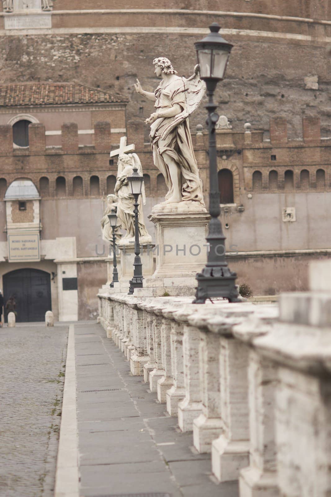 Statues line the bridge (Pont Sant' Angelo) over the River Tiber leading to the ancient Castel Sant' Angelo in Rome, Italy.