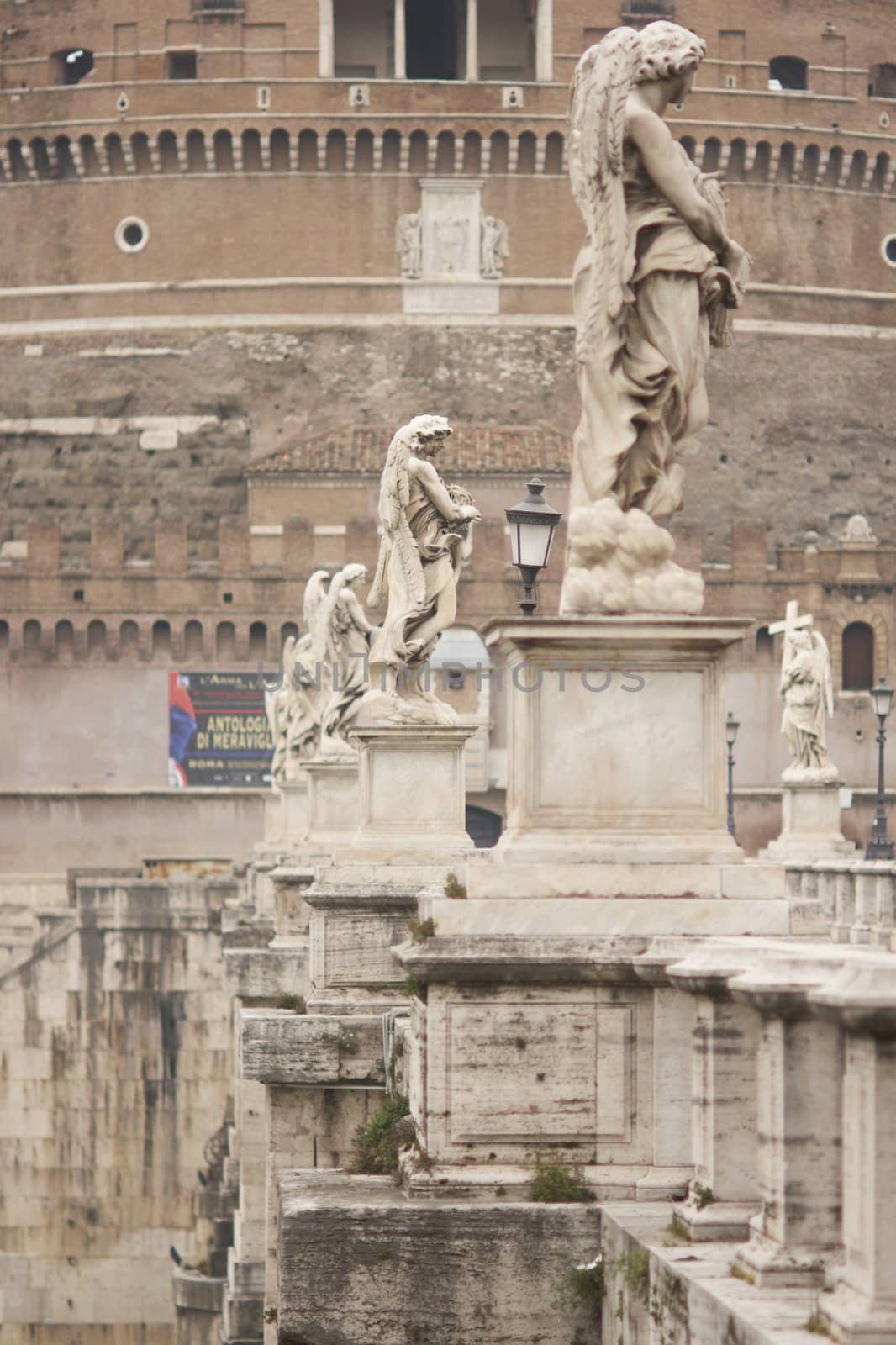 Statues line the bridge (Pont Sant' Angelo) over the River Tiber leading to the ancient Castel Sant' Angelo in Rome, Italy.