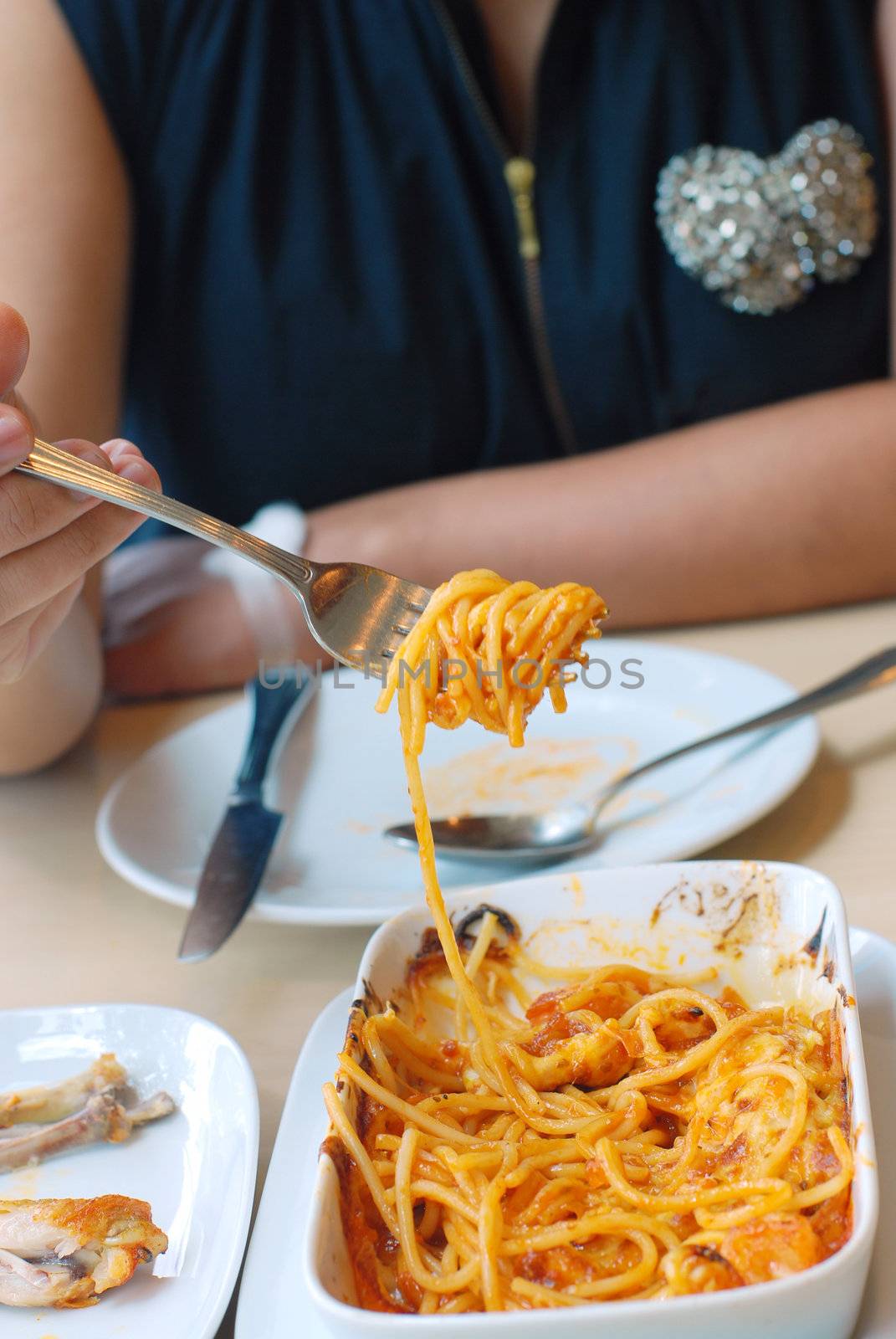 woman eat spaghetti with the great flavors of fresh shrimp and blended in tomato sauce, baked & topped with mozzarella cheese.