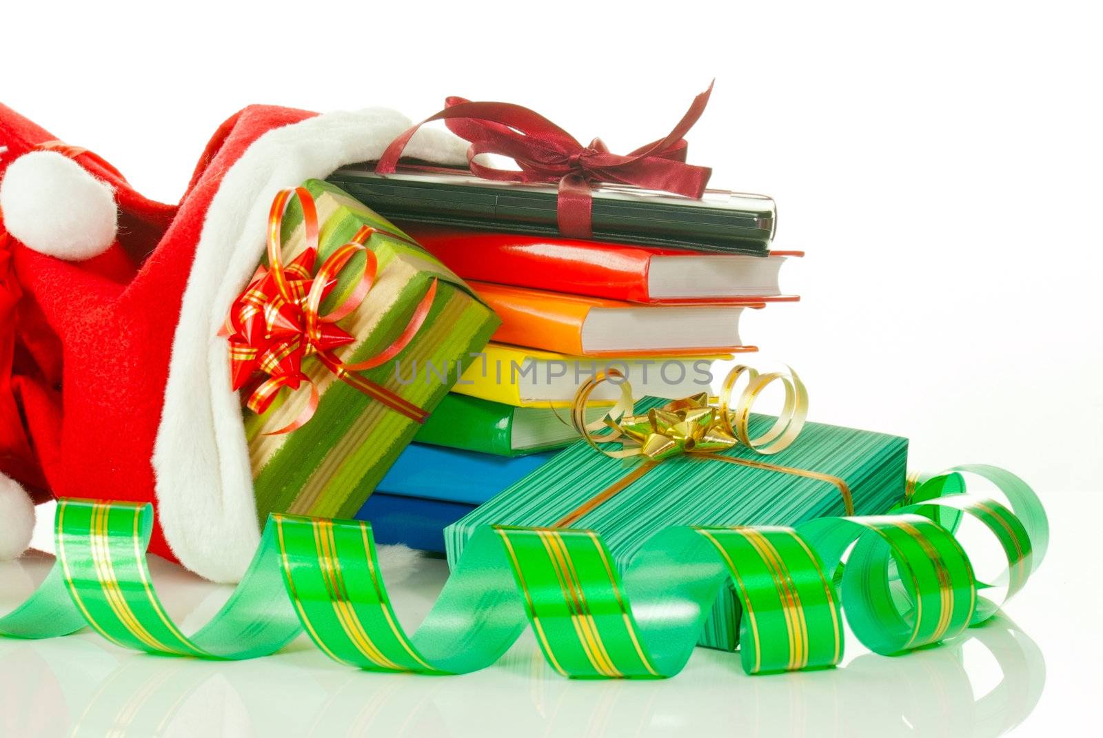 Christmas presents with e-book reader and books in bag against white background