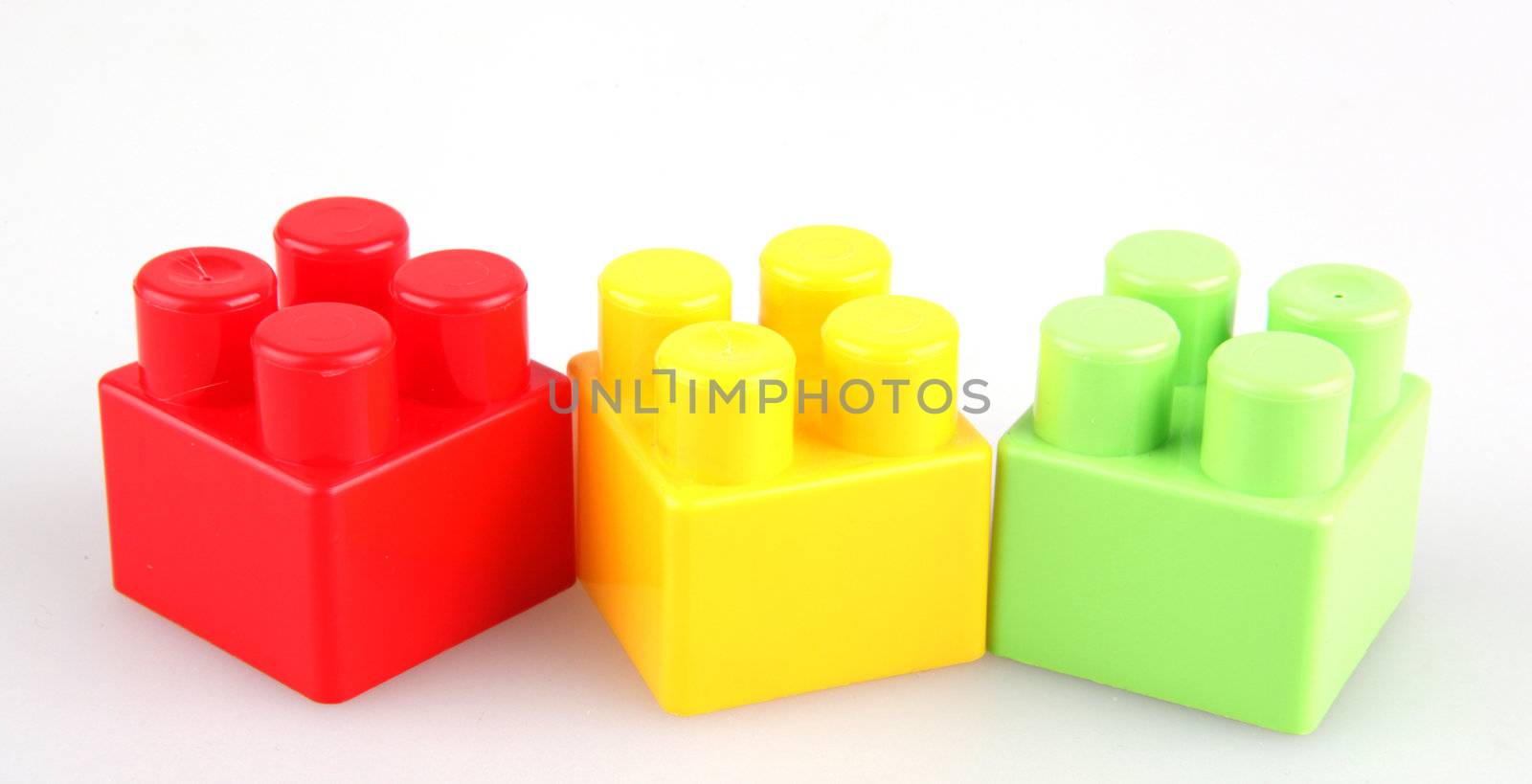 Plastic toy blocks on white background