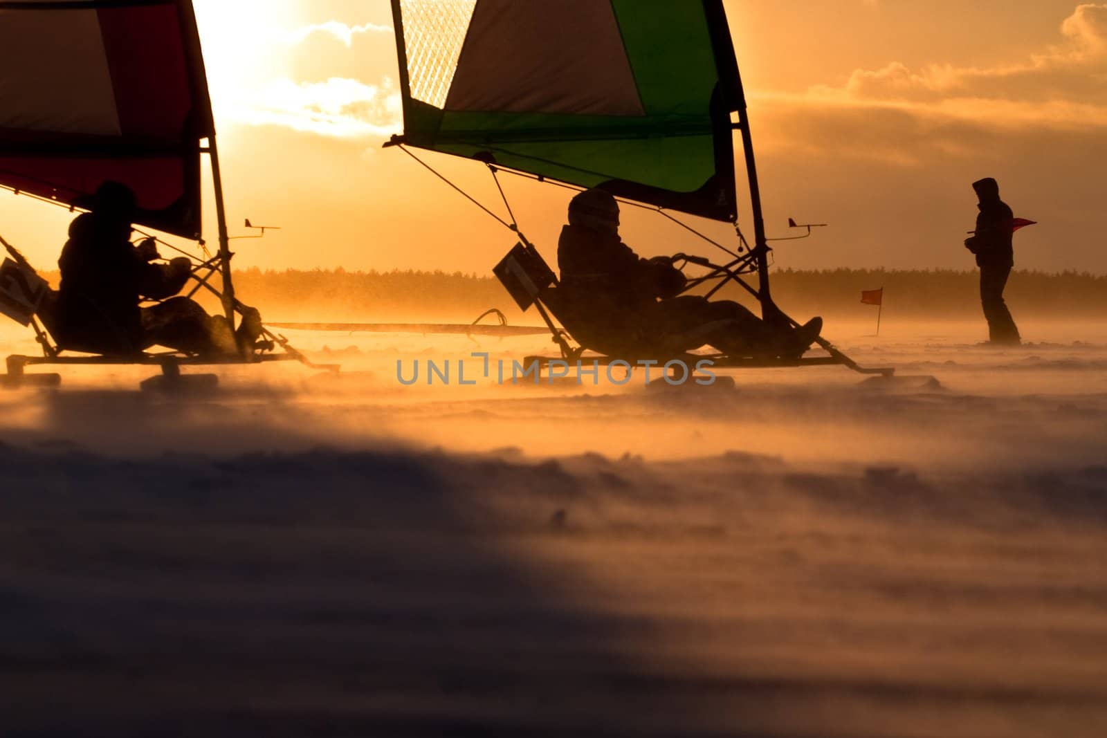 Ice-sailor's speeding up in a race. Facing an extreme blizzard, strong wind