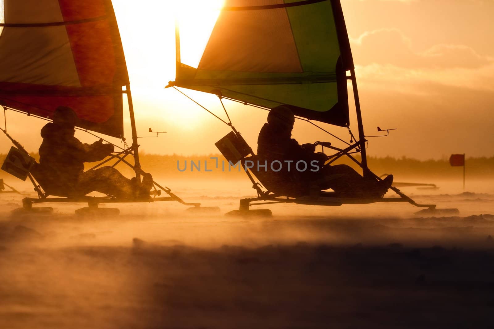 Ice-sailor's speeding up in a race. Facing an extreme blizzard, strong wind