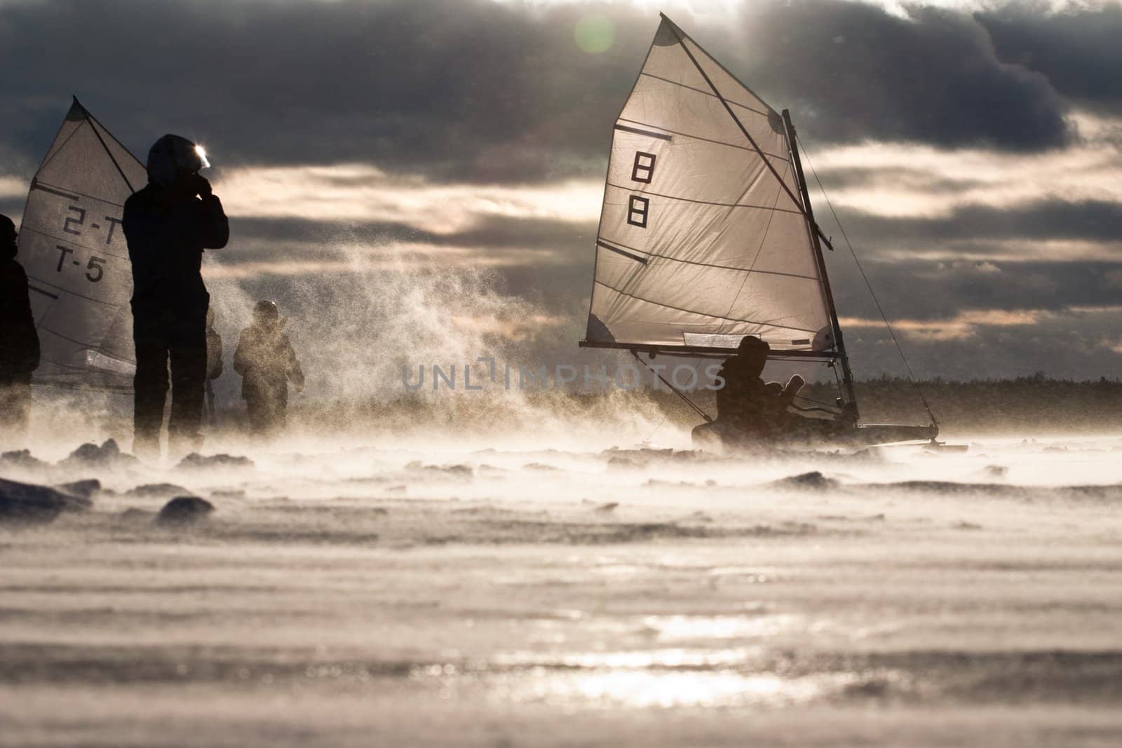 Ice-sailor's speeding up in a race. Facing an extreme blizzard, strong wind