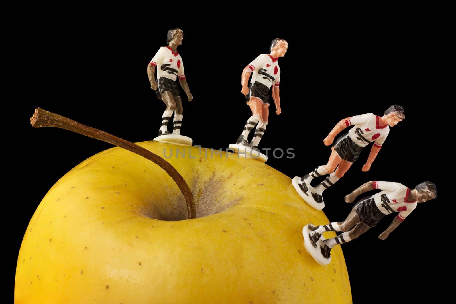 Yellow apple and sportsmen. Clipping paths are included.