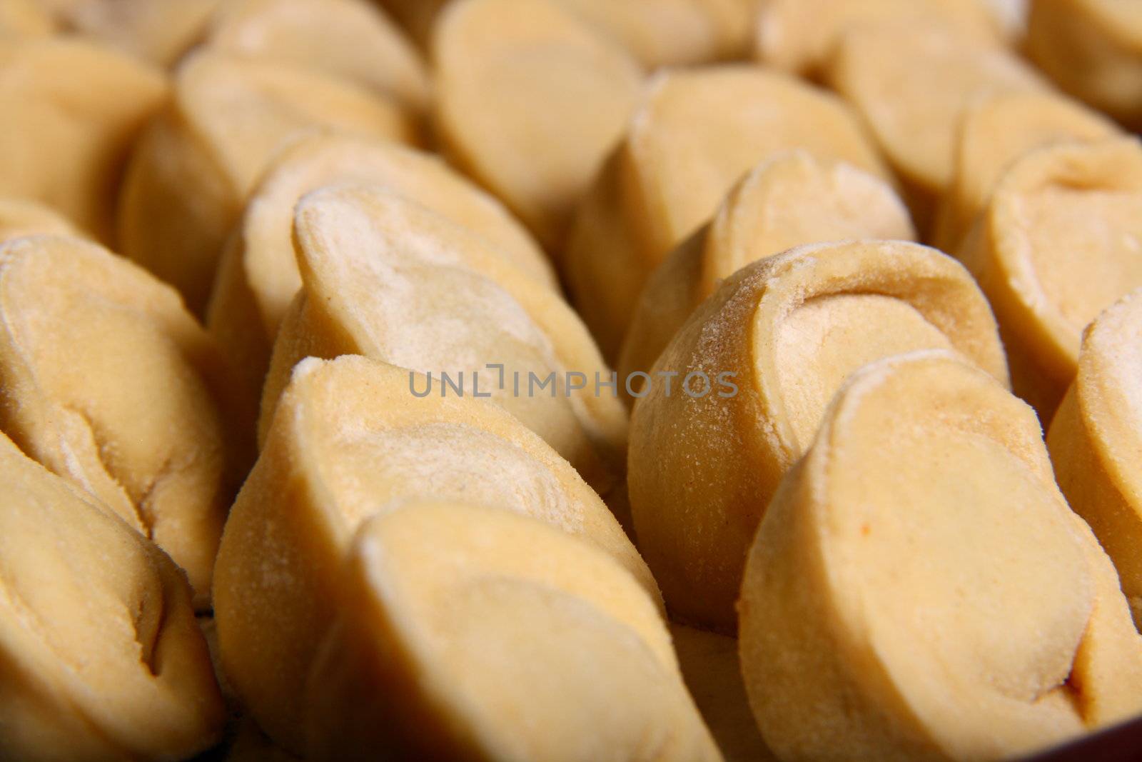 hand made ravioli getting prepared on table waiting for cooking