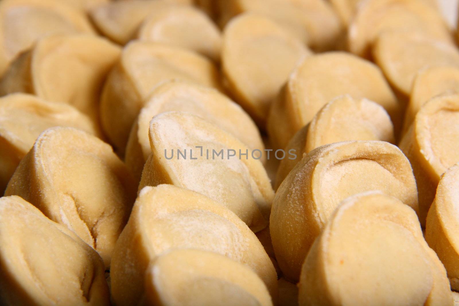 hand made ravioli getting prepared on table waiting for cooking