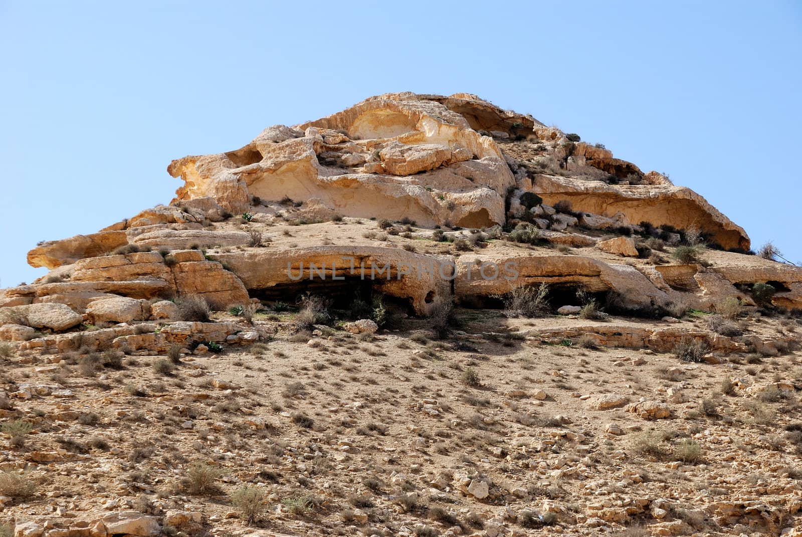 Ancient rocks under blue sky. Desert Negev, Israel.