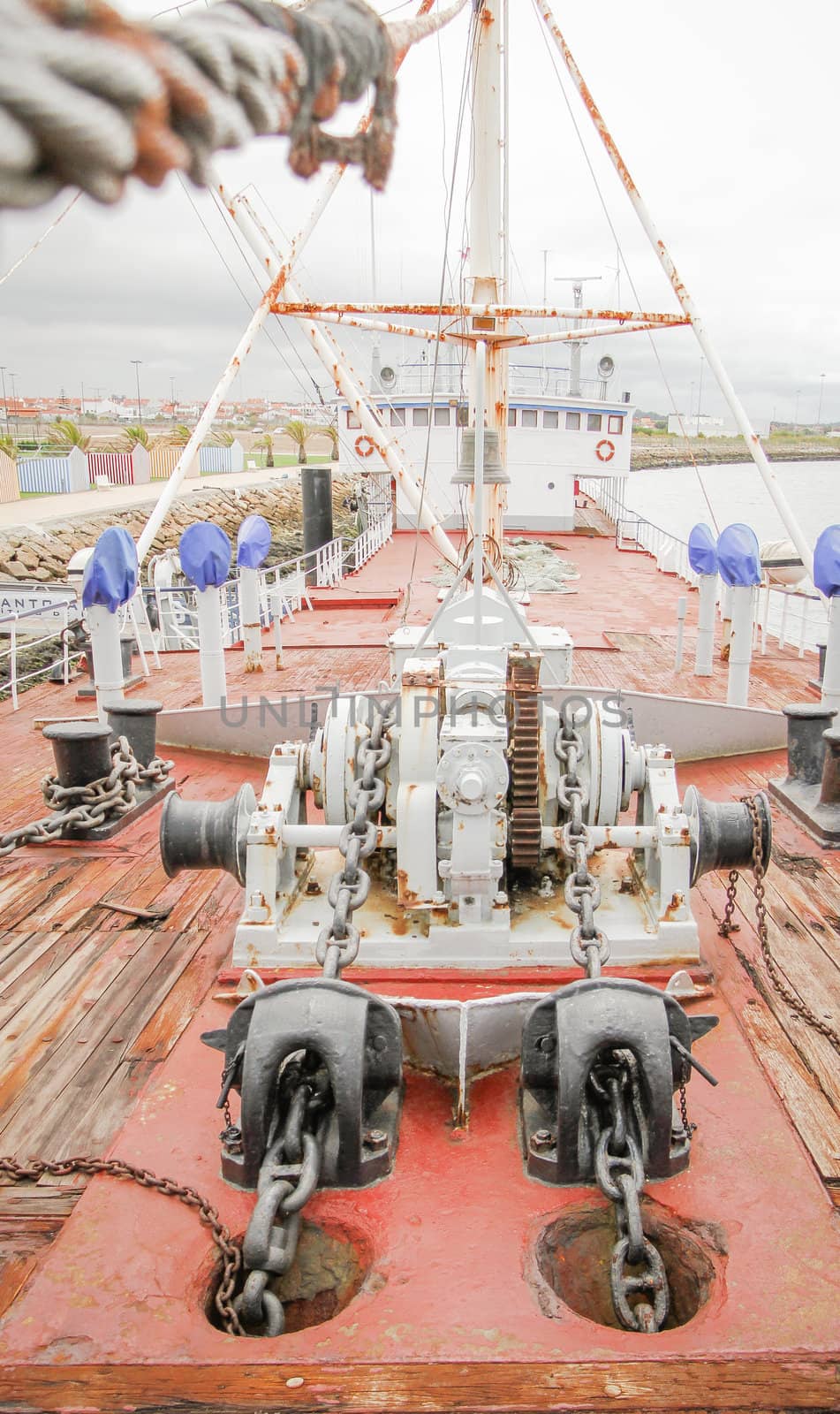 View of ship deck with engine anchors and chains