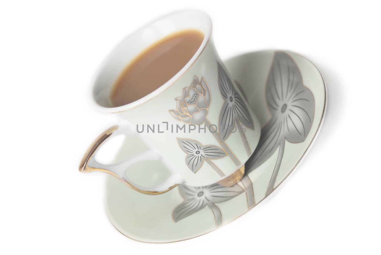 cup of coffee with milk or cream and saucer 