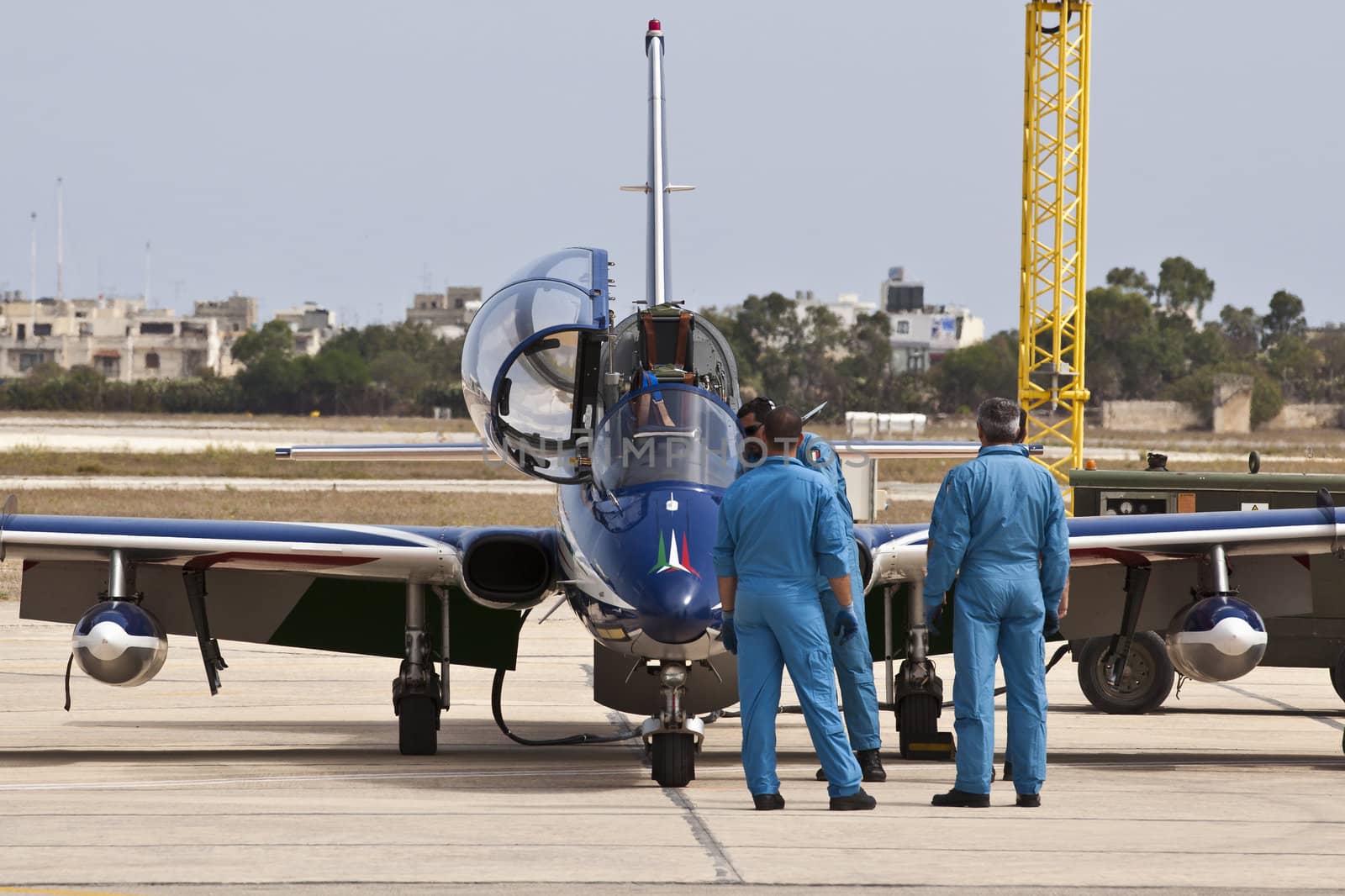 LUQA, MALTA - 25 SEP - Crew members from the Italian Frecce Tricolori aerobatic team check their aircraft before an aerial display during the Malta International Airshow on 25 September 2011